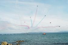 The Vixen Break at the end of the Red Arrows display. In the background is LE Ciara (Irish Naval Service) and the Clare mountains in the distance. Photo: Joe Desbonnet